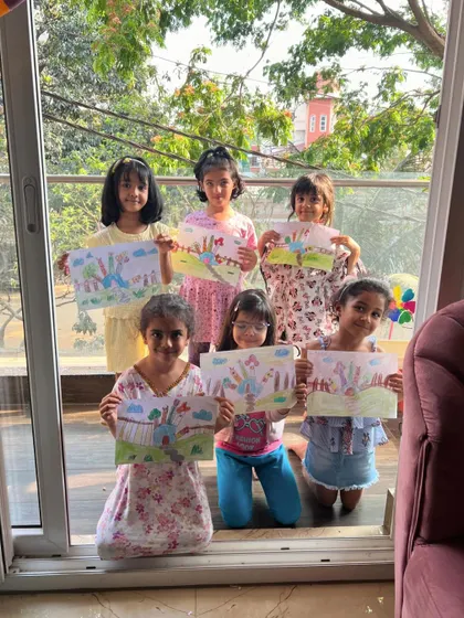 A whole class of proud artists showing off their "Hand House" drawings. It's amazing how a simple hand outline can spark so much creativity.