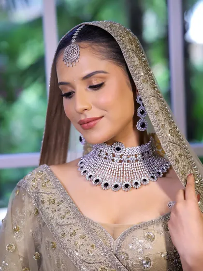 Timeless ivory elegance. This look features a soft base and bronze eyes, perfect for brides who want a traditional yet sophisticated makeover.