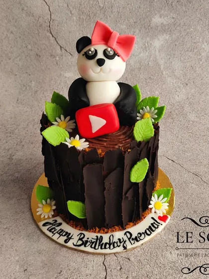 The panda is back. This one-pound Chocolate Truffle cake features a cute fondant panda holding a YouTube logo, sitting on a chocolate bark-covered cake.