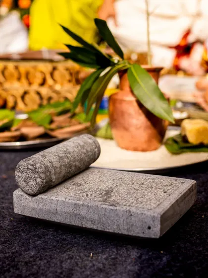 A traditional grinding stone ('ammi kallu') used in South Indian wedding rituals, showcasing the importance of cultural details.