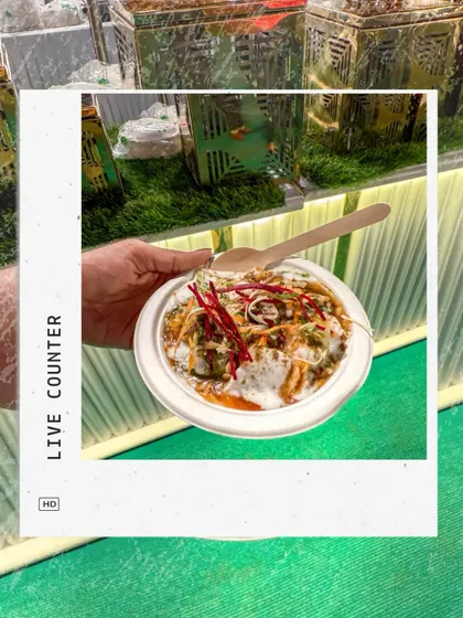 A guest receives a freshly prepared plate of chaat from our live counter. We focus on creating interactive food experiences that are both delicious and memorable.