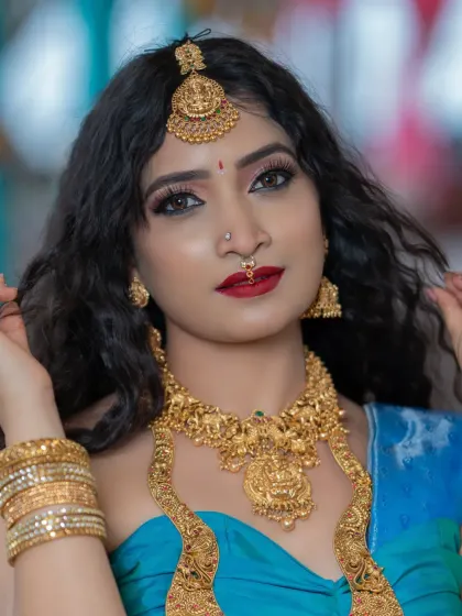A close-up portrait showing the dramatic eye makeup and flawless skin.