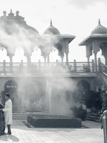A dreamy, black and white photograph that gives a timeless feel to this royal shoot. The mist around the fountain adds a layer of mystique and romance to the palace courtyard scene.