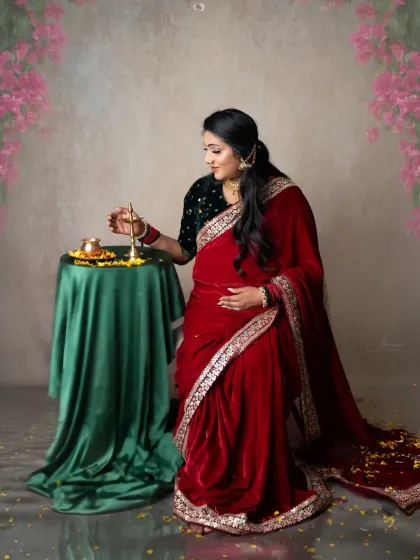 A moment of quiet ritual. The mom-to-be lights a diya, a beautiful symbol of hope and new beginnings, in this traditional maternity session.