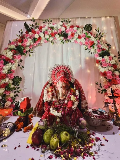 We love decorating for home pujas like Ganesh Chaturthi. Here, we created a beautiful floral arch with pink and white roses around the Ganpati idol, complemented by a soft, illuminated backdrop to make the celebration at home feel extra special and divine.