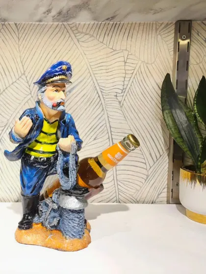 A fun and quirky bottle holder featuring a sailor figure. It's a great conversation starter and a perfect addition to your home bar.
