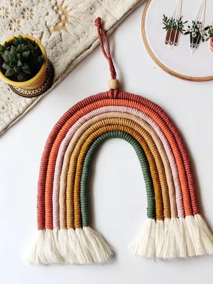 This earthy rainbow hanging looks beautiful styled with a plant and other natural decor.