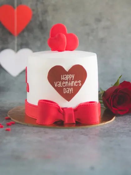 A mini Valentine's love cake with a big red bow. It's an adorable treat to awe your valentine.