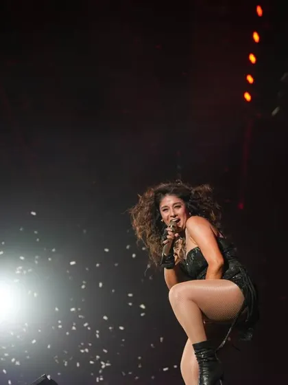 Sunidhi working the stage in Mumbai, with confetti falling around her.