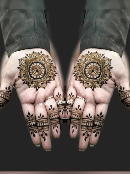 A simple and elegant mandala design for someone who wants a minimal look. The focus is on the central pattern and delicate finger details.