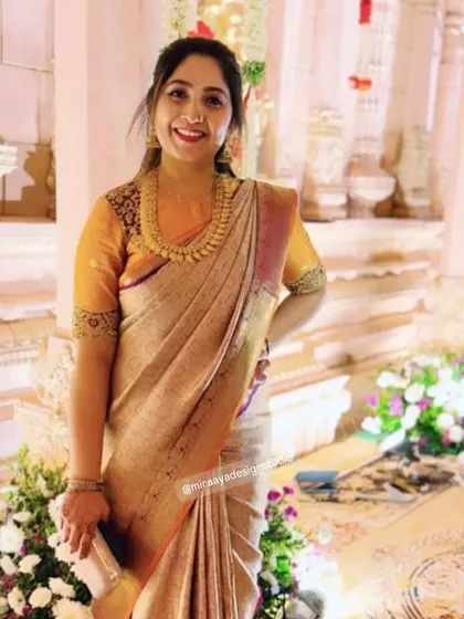 A gorgeous client ready for a wedding. Her custom mustard yellow blouse with brocade sleeves provides a rich contrast to her elegant beige silk saree.
