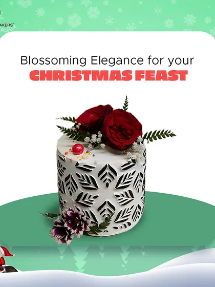 For a more elegant Christmas celebration, this cake features a beautiful white stencil design and is topped with fresh red roses. It's a sophisticated nod to the festive season.