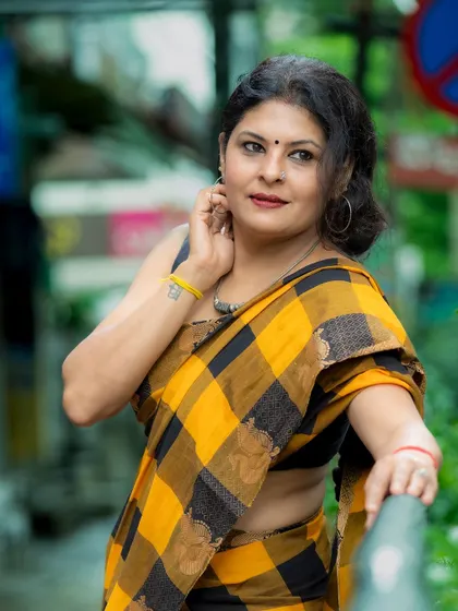 Another angle of the checkered saree look, showing how it can be styled for a relaxed yet put-together appearance.