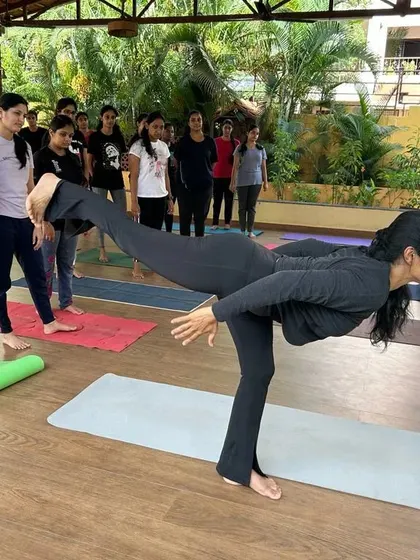 Demonstrating Virabhadrasana III to a group of eager students. Leading by example is a key part of my teaching, showing the focus and strength required for balancing postures.
