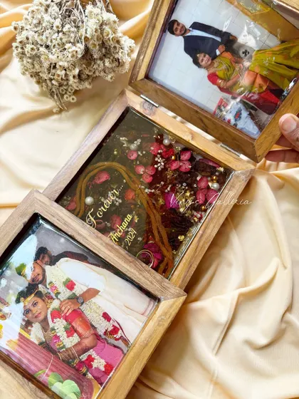 This view shows the beautiful way the folding frame opens up to reveal the preserved memories inside. The dark-toned flowers were enhanced with vibrant red hydrangeas to add life and color.