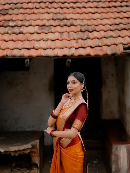 A wider view that sets the scene. The traditional tiled roof and weathered walls provide a perfect, authentic backdrop for this classic bridal portrait.