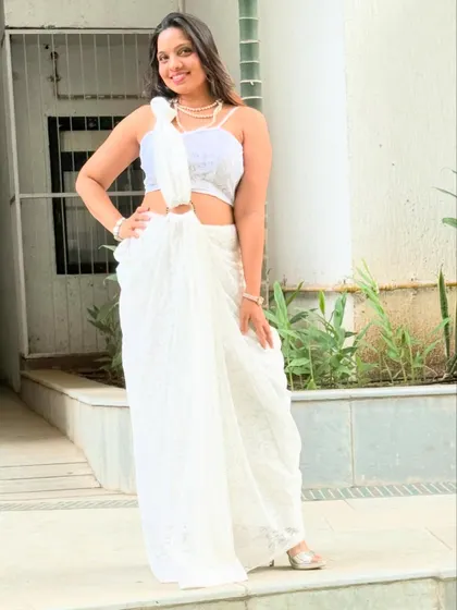The full look of the white lace saree, styled with one bangle and one knot for endless grace.