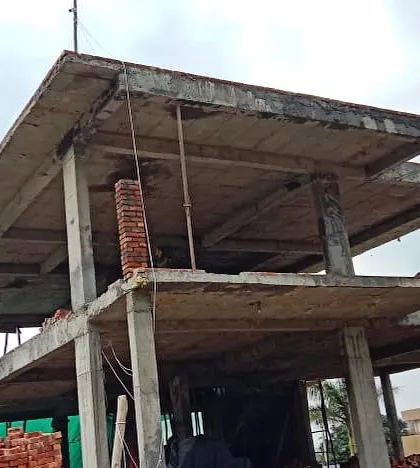 The bare concrete structure of a building, showcasing the cantilevered slabs and columns that form the architectural backbone of the project.