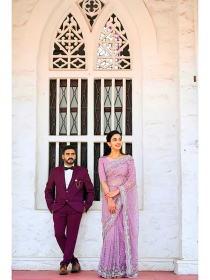 A beautiful couple poses against a white architectural backdrop. We help you find the perfect locations and settings for your pre-wedding and wedding photoshoots.