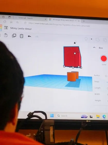 A student works on a 3D design using Tinkercad on a computer. Our workshops teach the full pipeline, from digital design to physical object.
