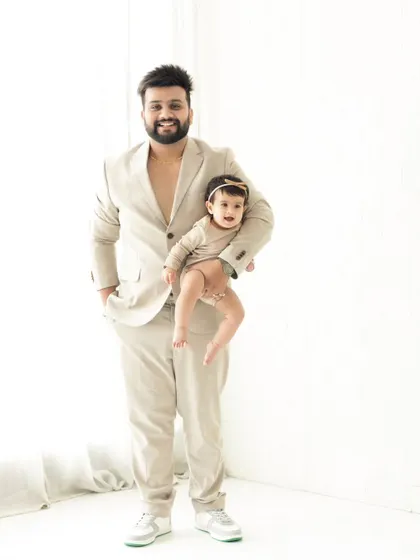 A stylish dad and his equally cool baby. This portrait showcases a modern, fun vibe, proving that family photos can be fashionable and full of personality.