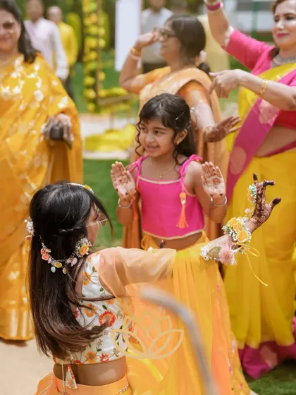 The joy of mehendi is for all ages! A beautiful candid moment of little ones dancing and showing off their henna at a party.