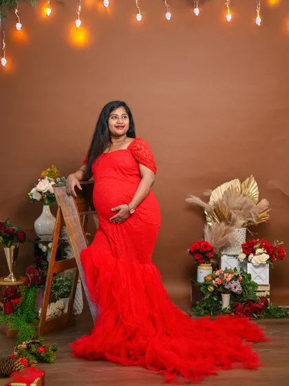 A series of solo portraits featuring this elegant red gown. The warm lighting and festive props create a very glamorous look.