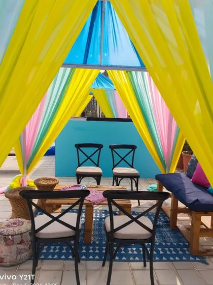 A closer look inside the colorful cabana, showing the comfortable and stylish seating arrangement we provide for guests.