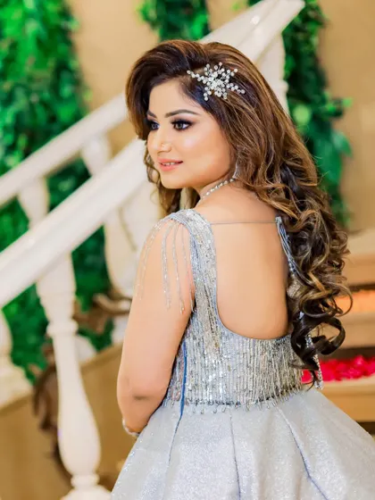 A beautiful back-shot of the bride, showcasing the detailed beadwork on her gown and her elegant hairstyle. We focus on capturing the beauty of the bridal attire from all angles.