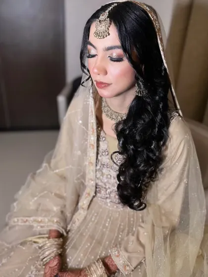 A candid shot showing the soft, shimmery eye makeup that complements her delicate jewellery.