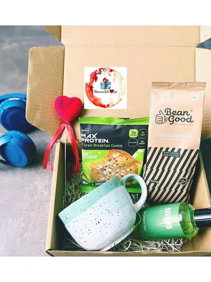 A health-conscious gift box for him. This hamper includes a protein cookie, peanut butter powder, a citrus-scented shower gel, and a stylish ceramic mug.