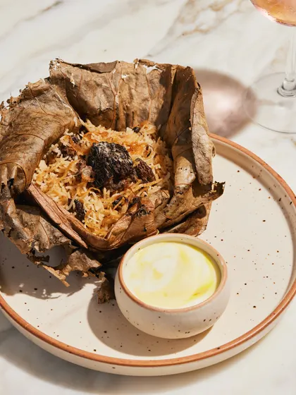 Our Gucchi Pulao, a fragrant rice dish made with prized morel mushrooms, cooked in a sealed lotus leaf to infuse it with aroma. A true delicacy.