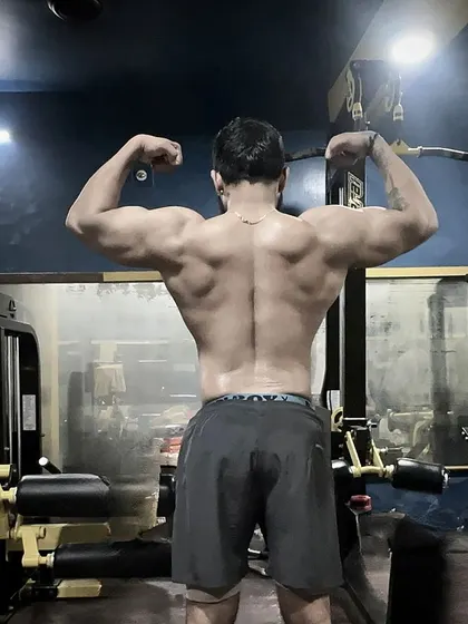 Conquer from within. A powerful back double biceps pose showing the results of countless rows, pull-ups, and deadlifts.