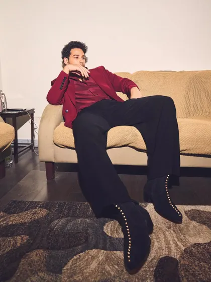The studded boots are the star of this shot. They add a rock-and-roll edge to Siddhant's Manish Malhotra outfit, proving that footwear can make or break a look.