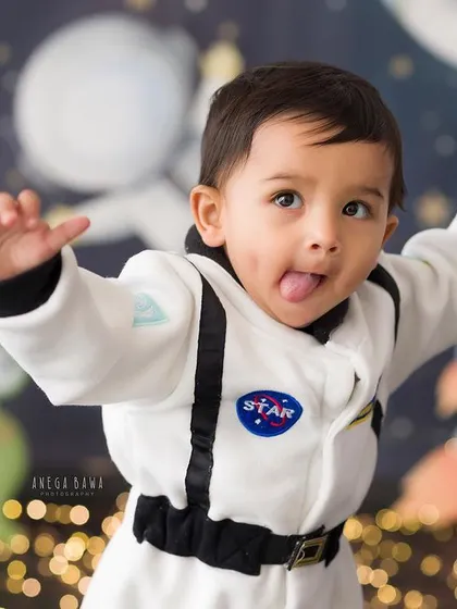 A cheeky astronaut reporting for duty. This little one's playful expression is out of this world! Themed shoots are a great way to capture your child's imagination.