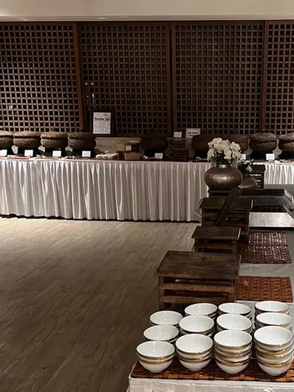 A wide shot of a buffet setup. The clean lines, white linens, and rustic serveware create a look that is both elegant and inviting.