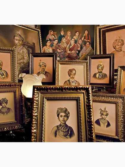 A detail shot focusing on a collection of ancestral portraits. This image captures the historical essence and storytelling details that make a heritage property unique.