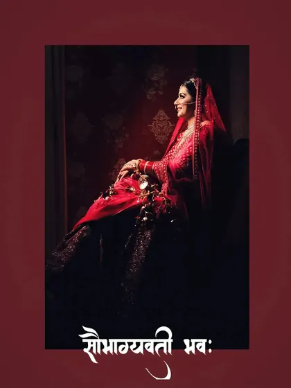 A regal portrait of bride Nikita seated, her red lehenga and pose exuding grace and tradition.