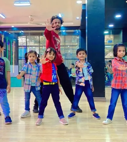 Striking a pose during a dance routine. Our classes help kids develop coordination and body awareness while they have fun.