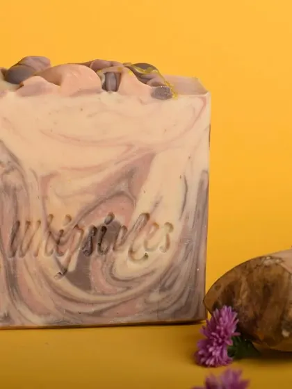 A close-up of the Sandalwood and Vetiver soap, showing its rich texture and color. The scent is a harmonious blend perfect for the festive season.