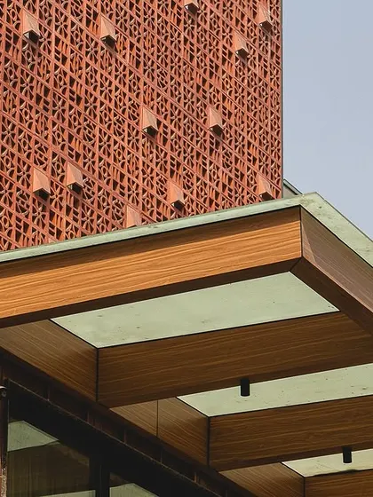 A close-up of the facade of The Brick House in Gurgaon. We used a custom terracotta jali screen, which adds a layer of intricate texture and plays with light and shadow, demonstrating our passion for using traditional materials in innovative and contemporary ways.