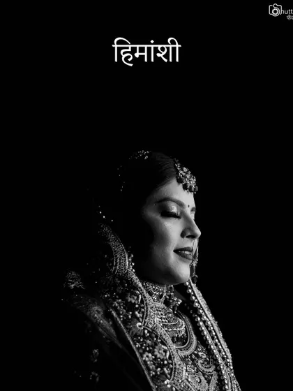 A classic, elegant black and white portrait of the bride. This timeless style focuses on her serene expression and the intricate details of her attire.