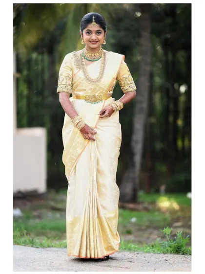 My dear bride Nithu from Australia, looking elegant in a cream Kanjivaram saree with a custom-designed blouse.