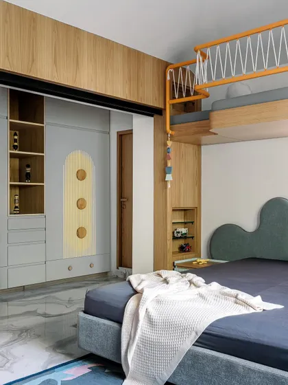 For this children's room in Cocoon House, we created a playful yet functional space with a custom bunk bed and integrated storage. The design uses a soft color palette with pops of yellow, while the cloud-shaped headboard and whimsical details spark imagination without creating clutter.