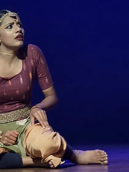 A solo performer captures a moment of intense emotion during the 'Rasadrishta' show. Our productions focus on bringing human feelings to life through expressive dance.