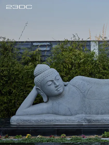 A close-up of the serene, reclining Buddha statue that presides over the Ananda courtyard. Its presence infuses the space with a sense of peace and mindfulness, reminding us that happy homes are where peace resides.