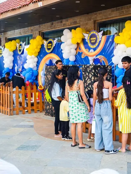 Guests lining up to play the various game booths at a Sonic-themed party, showing the popularity of these attractions.