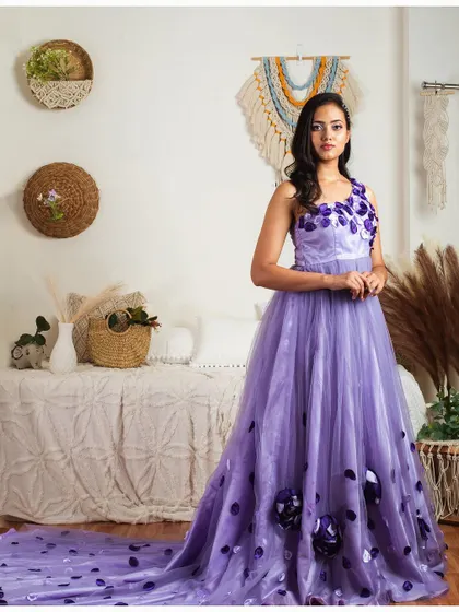 A full view of my lavender gown with 3D floral details scattered down the skirt and a long, flowing trail.