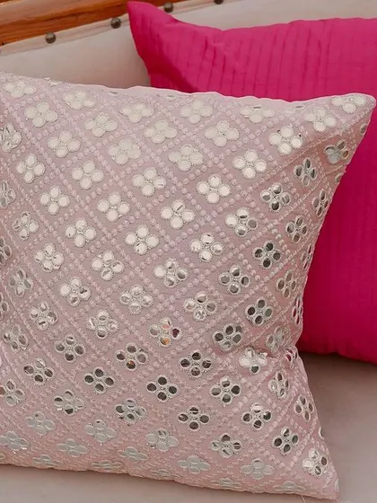 A detail shot of the seating, showing a beautiful pink cushion with intricate mirror work. We believe these small, high quality details are key to creating a luxurious and cohesive wedding design.