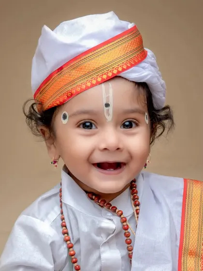 A heart-melting smile from a baby in our Varkari costume. These close-up shots are perfect for capturing your child's innocent expressions.